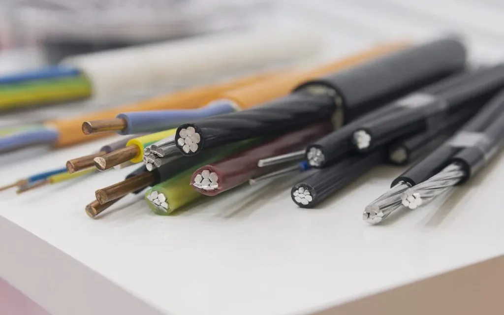 How do wires and cables function within an electrical system?